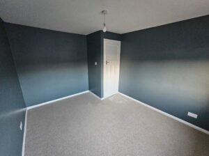 fresh painted room in striking green and white woodwork