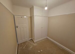 fresh white gloss painted doors woodwork and built in cupboard